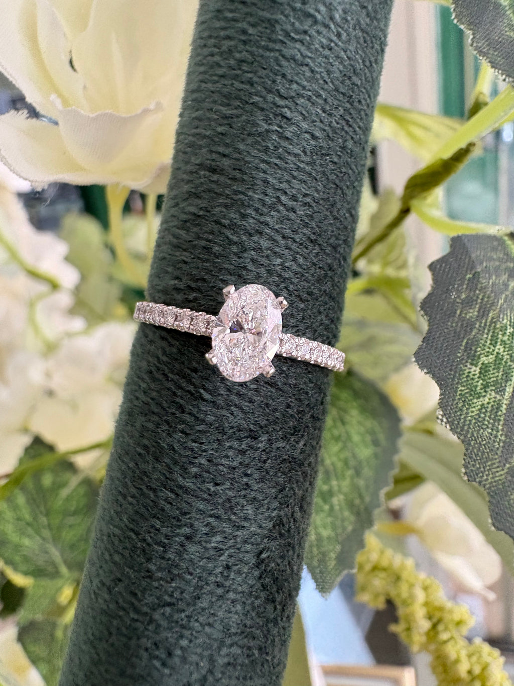 Platinum oval solitaire diamond ring with diamond shoulders